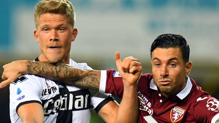 Andreas Cornelius of Parma Calcio competes for the ball with Armando Izzo of Torino FC