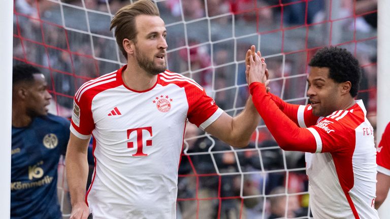 Harry Kane celebrates scoring his hat-trick with Serge Gnabry