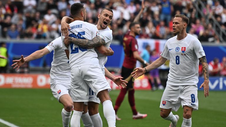 Ivan Schranz of Slovakia celebrates with Lukas Haraslin and Ondrej Duda after scoring against Belgium