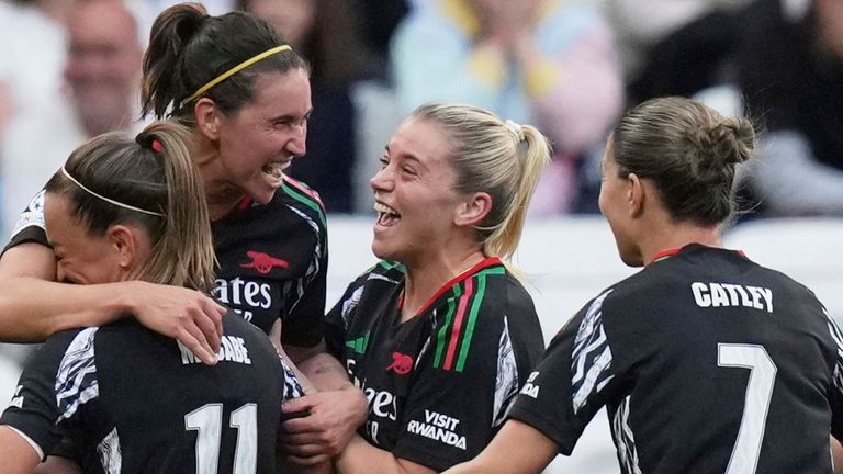 Arsenal's Mariona Caldentey, center, celebrates after scoring her side's second goal during the women's Champions League semifinals, second leg, soccer match between Olympique Lyonnais and Arsenal at OL Stadium in Decines, outside Lyon, France, Sunday, April 27, 2025. (AP Photo/Thibault Camus)